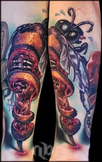 honey bee with stinger engaged and ripping out the internal anatomy of the bee as it flies away color tattoo by nick baxter in austin texas
