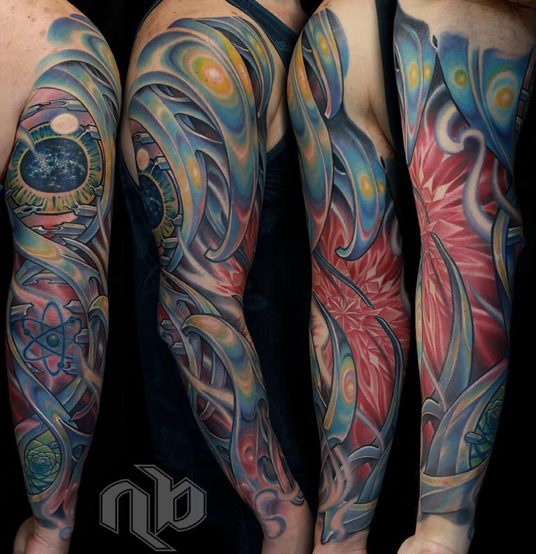 Four views show a large arm tattoo with flowing blue-grey biomechanical forms, red crystalline patterns, glowing orbs, an eye, and atomic motifs.