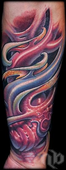 Medium arm tattoo shown in close view, with interlocking blue, red, pink, and cream ribbon-like fleshy bio-organic forms.