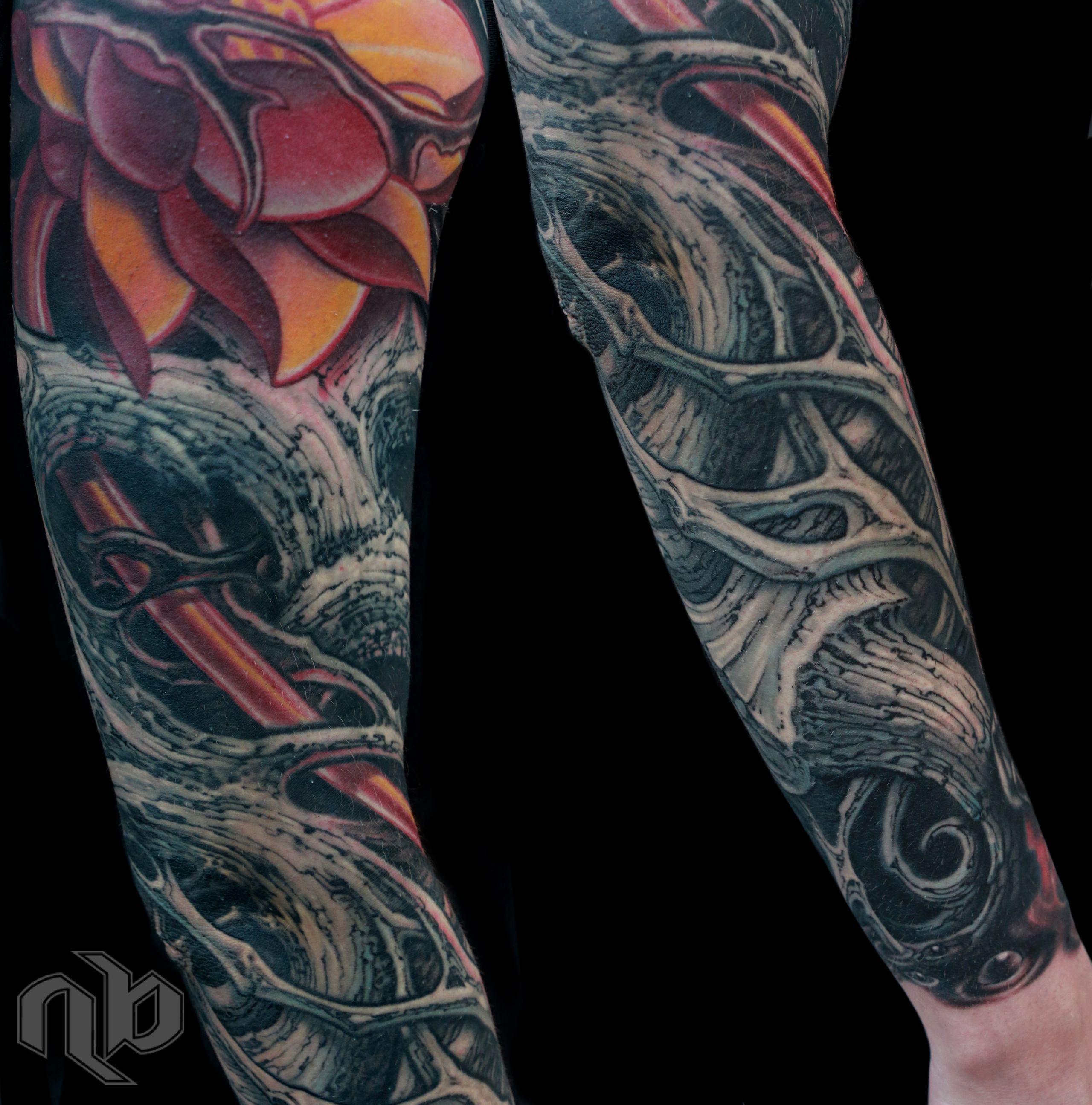 Two close views of a large arm tattoo show a red-orange lotus amid dark vine-like bio-organic forms and glowing red accents.