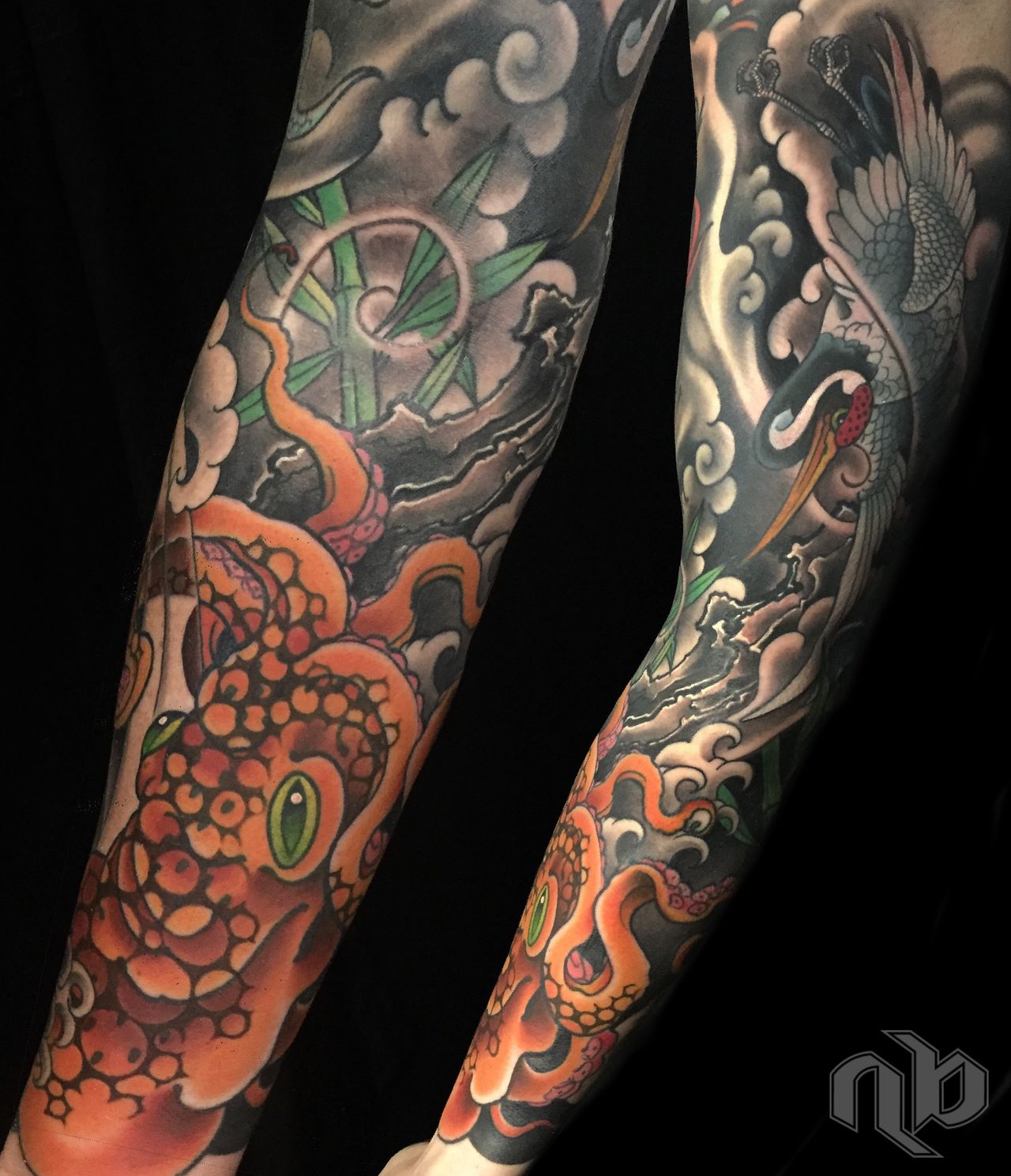 Two close views show a large japanese woodblock print styled arm tattoo of an orange octopus and grey crane amid stylized waves, clouds, and green bamboo.