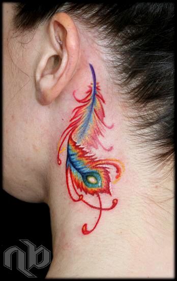 Close-up of a small, colourful peacock feather tattoo with red flourishes on the neck behind an ear.