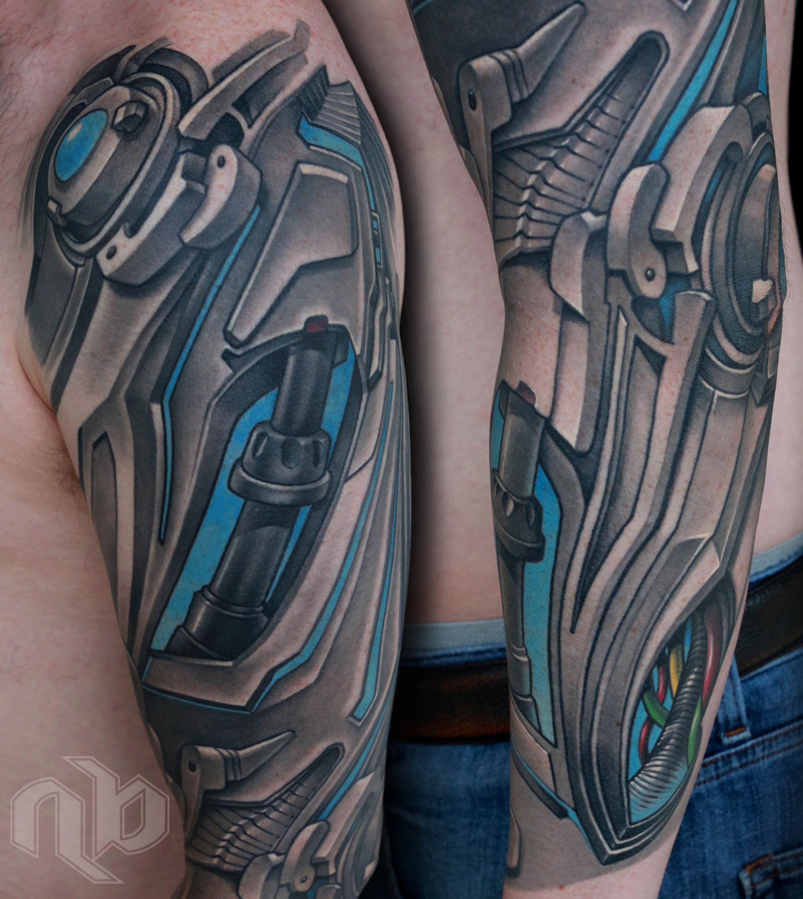 black and gray biomechanical robot droid machinery full arm sleeve tattoo with glowing blue background by nick baxter in austin texas