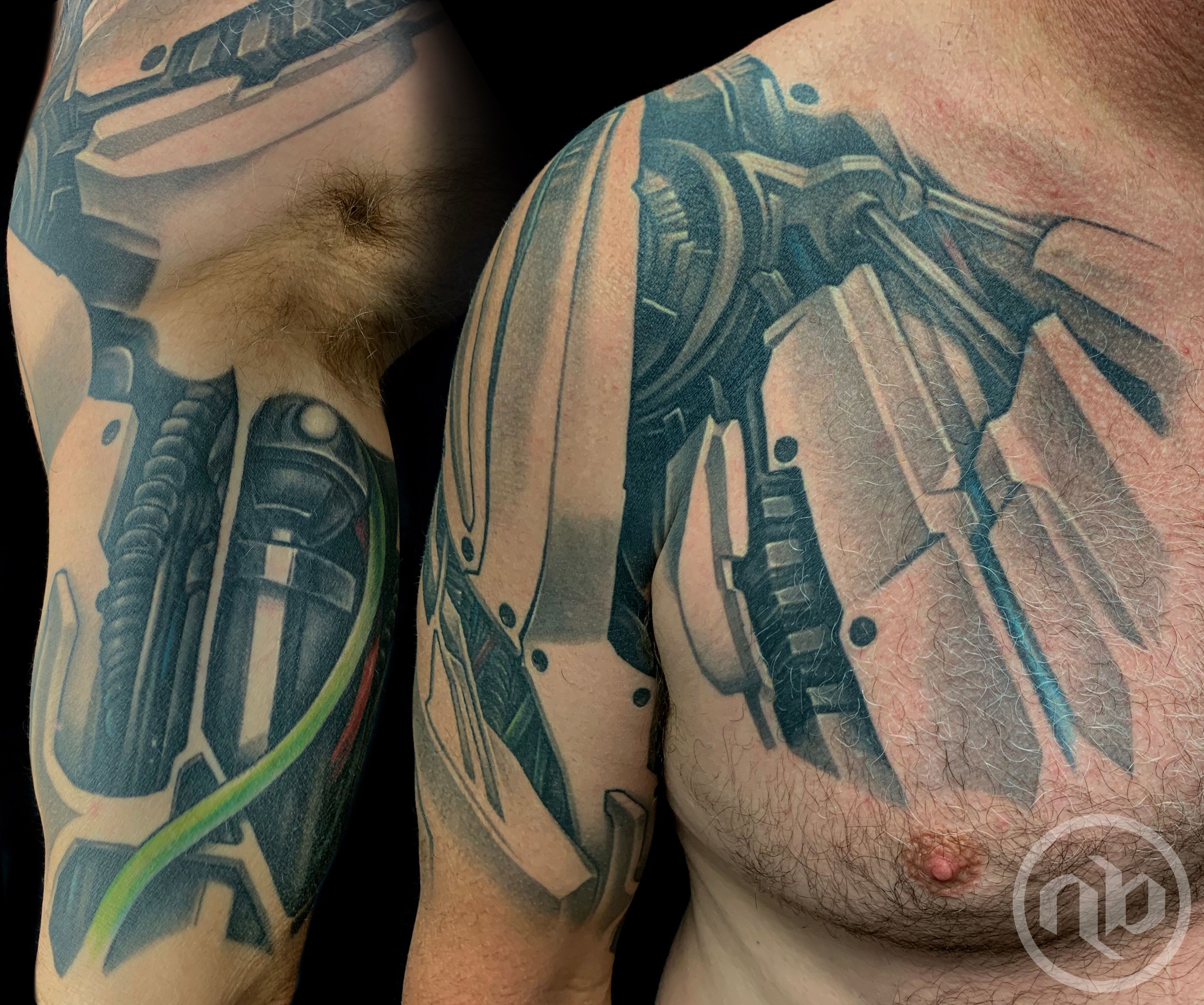 Close view of a black and grey biomechanical tattoo of robot armor spanning a bent arm, shoulder, and chest, with panels, joints, and colored cables.
